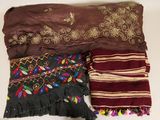 several different types of scarves are laid out on a table