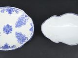 two blue and white dishes on a black surface