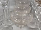 many wine glasses sitting on a table next to each other