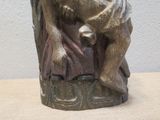 a statue of a man sitting on a chair