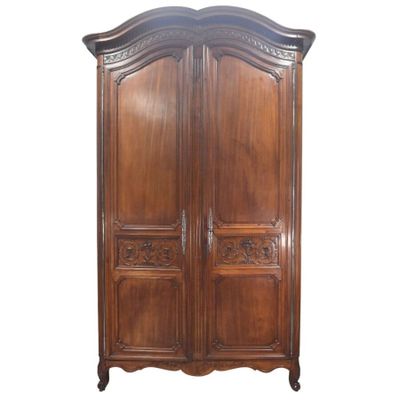 an image of a wooden armoire with carvings on the doors