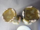 two vases with asian writing on them on a table