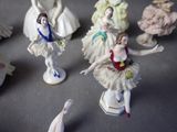 several figurines of ballerinas are displayed on a table