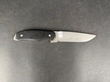 a knife that is laying on a table