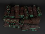 a group of brown and green cloths on a black surface