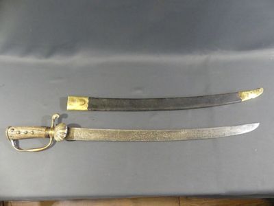 pair of old swords with gold handles on a table