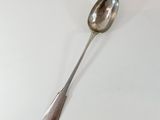 a spoon that is sitting on a white table