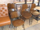 six chairs and a table in a room with a brick wall