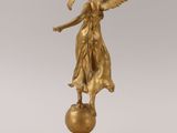 statue of an angel holding a globe on a marble base