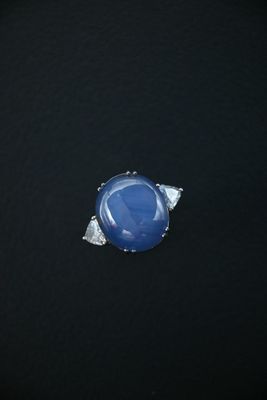 an image of a blue stone ring on a black surface