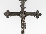 a metal cross with a jesus on it on a white background