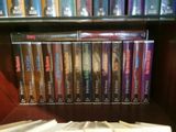 a lot of dvds on a shelf in a book case