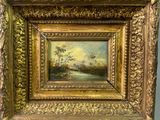 tableau représentant un paysage avec une rivière et des arbres, dans un cadre doré