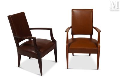 two brown leather chairs sitting next to each other on a white surface