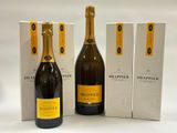 three bottles of champagne and two boxes of wine on a white surface