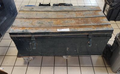 a large metal box sitting on top of a tiled floor
