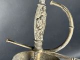 an image of a sword with a handle on a stand