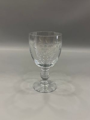 a wine glass that is sitting on a table