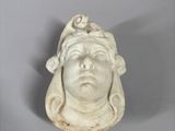 statue of a woman ' s head with a bird on her head