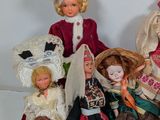 a lot of dolls that are sitting together on a table