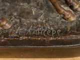 a bronze statue of a horse on a wooden table
