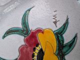 a vase with a flower painted on the side of it