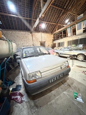 a car that is parked in a garage with other cars