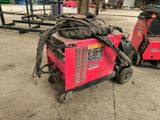 a red machine that is sitting on the ground