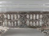 a silver bench that is sitting on a table