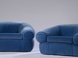 pair of blue velvet lounge chairs with matching arms and legs