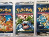 three packs of pokemon trading cards sitting on top of each other