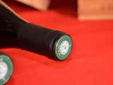 two bottles of wine sitting on a red table