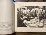 an open book with a picture of a group of people sitting at a table