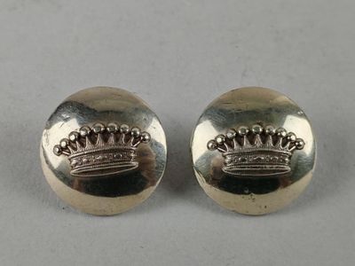 a pair of silver earrings with a crown on them