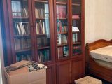 a bedroom with a bed and a bookcase in it