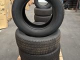 tires stacked on a pallet in a warehouse with pallets in the background