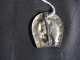 a silver heart shaped object on a black cloth