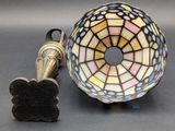 a lamp that is sitting on a table next to a piece of metal