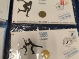 two olympic medals are on display on a table in a room