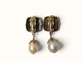pair of gold and pearl earrings on a white background