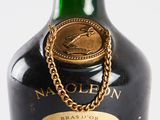 a bottle of liquor with a gold chain on the neck