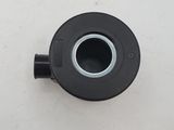 a black pipe on a white surface with a small hole in the middle