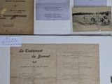 several old documents are displayed on a table with a pen and paper