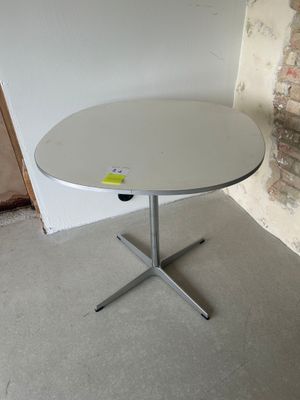 a white table with a yellow sticker on it