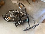a bicycle that is laying on the ground in the garage