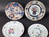 three plates with different designs on them sitting on a table