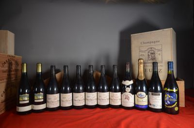 bottles of wine are lined up on a red table cloth