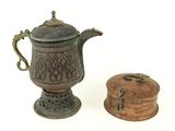 a small teapot and a small box on a white surface