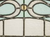 a close up of a stained glass window with a gold frame