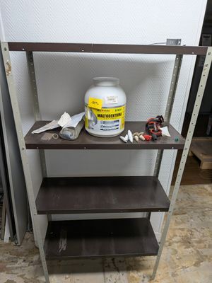 a shelf that has a bucket of paint on it